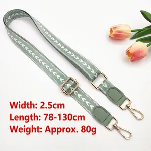 Adjustable 2.5cm green fabric shoulder strap with white arrows and golden metal hooks