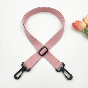 Detailed view of pink woven canvas strap with durable black plastic swivel hooks