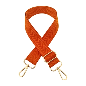 Detail view of orange arrow weave strap with adjustable gold lobster clasp buckles