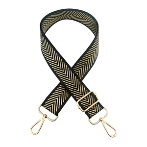 Detail of adjustable black and gold chevron strap with metallic swivel lobster clasps