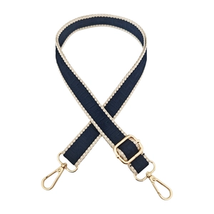 Detail of navy and beige geometric woven bag strap with golden metal lobster clasps