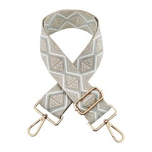 Detail of bohemian geometric embroidery on adjustable strap with gold metal swivel hooks