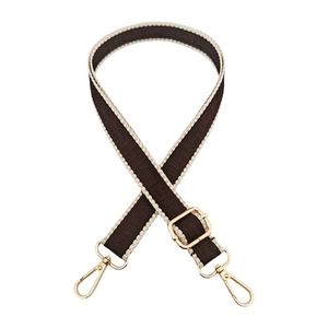 Detail of coffee-colored labyrinth pattern woven strap with gold metal lobster clasps