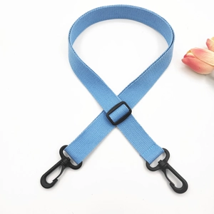 Detail of adjustable sky blue woven strap with black swivel hooks and plastic buckles