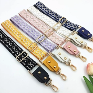 Collection of seven colorful ethnic jacquard embroidered bag straps with gold metal hardware