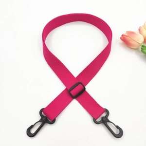 Close-up of rose red adjustable cotton shoulder strap with black swivel snap hooks