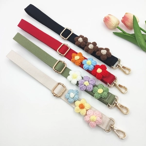Adjustable woven crossbody strap with handmade crochet flowers in various colors