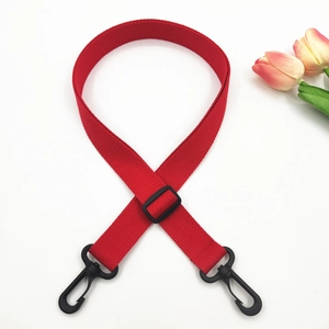 Close-up of red adjustable cotton crossbody strap with black swivel hooks and tulip decor