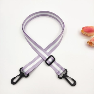 Detail of adjustable purple and white striped strap with durable black plastic swivel hooks