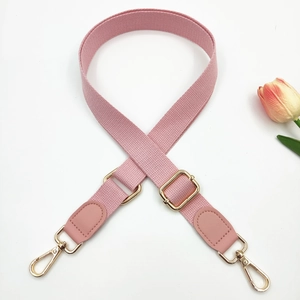 Adjustable pink shoulder strap detail with light gold buckles and lobster clasps