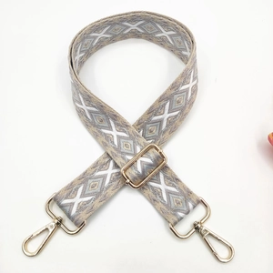 Close-up of geometric diamond embroidery on 3.8cm wide strap with gold hardware