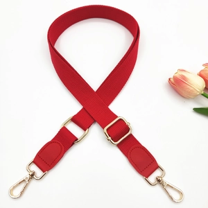 Adjustable red nylon shoulder strap with gold hardware and PU leather ends for bags