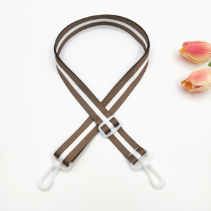 Adjustable brown and white striped bag strap with white plastic clips and tulips detail