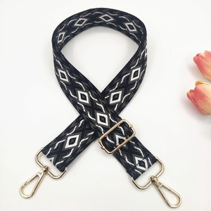 Detail of adjustable 3.8cm ethnic style embroidered bag strap with golden metal hardware