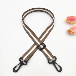 Detail of adjustable 2.5cm striped bag strap with black plastic swivel hooks and buckles