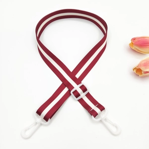 Detail of red and white striped adjustable nylon strap with white plastic swivel hooks