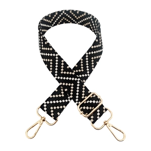 Adjustable black and white geometric woven shoulder strap with gold metal lobster clasps