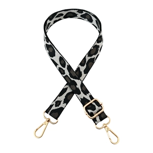 Detailed close-up of adjustable leopard print jacquard strap with gold metal hardware