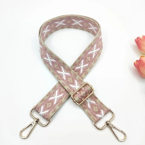Detail of 3.8cm ethnic embroidered strap with pink diamond patterns and gold metal hooks