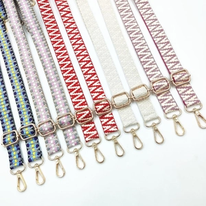 Detail showing various ethnic style woven bag straps with gold metal adjustment buckles