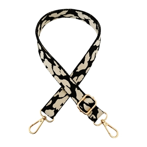 Detailed view of leopard jacquard bag strap with gold metal buckles and high-density texture