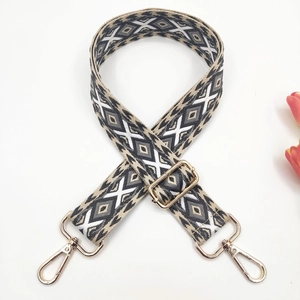 Close-up of geometric diamond embroidery on 3.8cm wide strap with gold lobster clasps