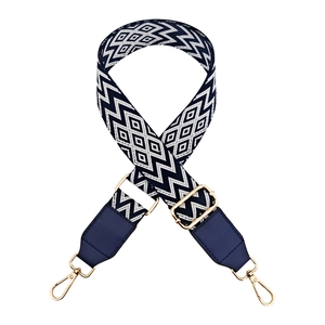 Detail of adjustable blue and white wavy woven strap with gold hardware hooks