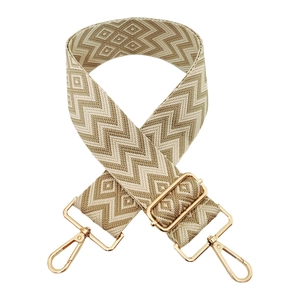 Detail of 5cm wide adjustable woven bag strap with golden buckles and wave patterns