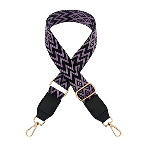 Detail of colorful wave pattern wide strap with leather ends and gold metal lobster clasps