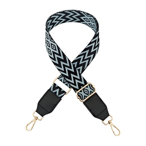 Macro detail of adjustable blue wave pattern wide strap with gold metal hooks and leather ends