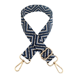 Macro detail of adjustable blue wavy woven shoulder strap with gold metal buckles