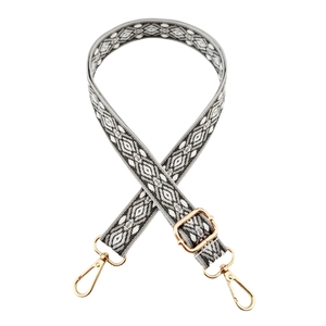 Detailed view of jacquard geometric pattern woven strap with gold metal lobster clasps