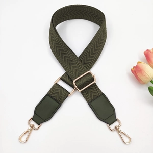 Detail of army green woven strap with chevron pattern and golden metal buckles