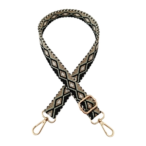 Detailed view of 2.5cm vintage jacquard strap with gold metal lobster clasps and buckles