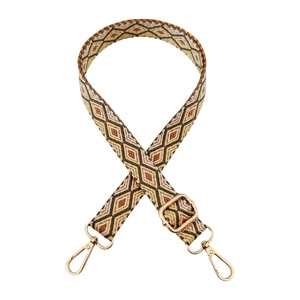 Detail of adjustable woven bag strap with geometric diamond pattern and gold metal hooks