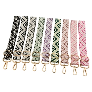 Adjustable woven shoulder straps with geometric patterns and gold metal hardware for bags
