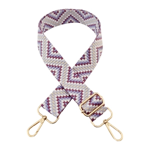 Detail of adjustable woven purse strap with purple geometric pattern and gold hardware