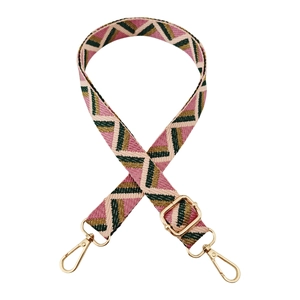 Detail of adjustable geometric jacquard bag strap with golden metal lobster clasps