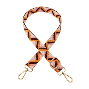 Detail of adjustable geometric strap with orange and brown waves and gold swivel hooks