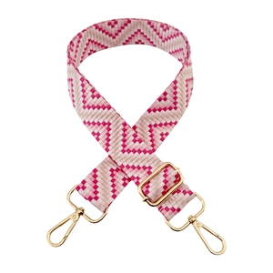 Close-up of pink and beige geometric woven replacement strap with gold metal buckles