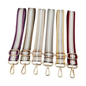 Adjustable woven shoulder straps with silver glitter thread and gold metal swivel hooks