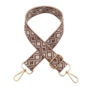 Close-up of geometric ethnic pattern bag strap with gold metal swivel snap hooks