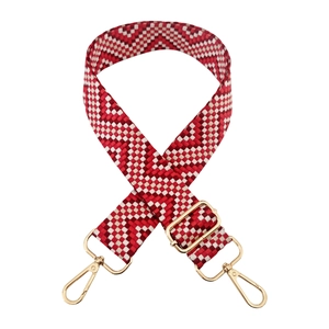 Detail of red and cream checkered woven bag strap with golden metal lobster clasps