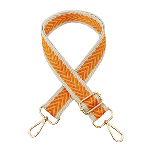 Detail of adjustable beige chevron shoulder strap with gold metal lobster clasps