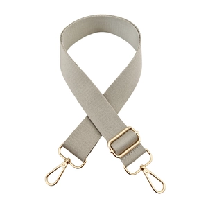 Detail of adjustable light grey wide nylon bag strap with polished gold metal hardware