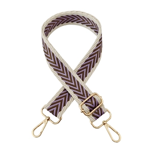 Detail of colorful jacquard wide strap with golden metal lobster clasps and slider