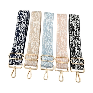 Adjustable crossbody bag straps with colorful snake prints and gold metal hardware