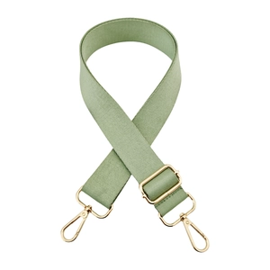 Detail view of light green woven strap with adjustable light gold metal hardware hooks