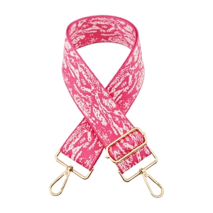 Detail of pink and white jacquard bag strap with polished light gold metal hooks