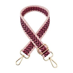 Detail of pink and black wave jacquard wide bag strap with gold lobster clasps